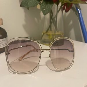sunglasses are by Chloe, a tan-like color, & they are OS.